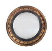 A REGENCY GILTWOOD CONVEX WALL MIRROR