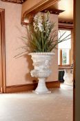 A MONUMENTAL PAIR OF CARVED MARBLE URNS, AFTER THE ANTIQUE
