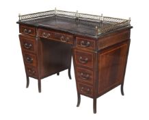 AN EDWARDIAN MAHOGANY AND SATINWOOD CROSSBANDED DESK, ATTRIBUTED TO JAMES SHOOLBRED & CO.