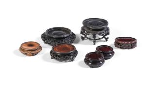 A GROUP OF SEVEN CHINESE WOODEN STANDS, VARIOUS SIZES AND DATES