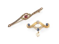 TWO SCROLLED BROOCHES
