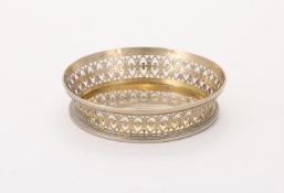 A SILVER GILT COLOURED WINE COASTER