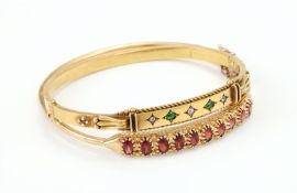 A VICTORIAN DIAMOND AND GREEN STONE HINGED BANGLE, CIRCA 1880