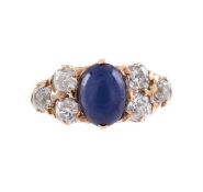 A DIAMOND AND SYNTHETIC STAR SAPPHIRE SEVEN STONE RING