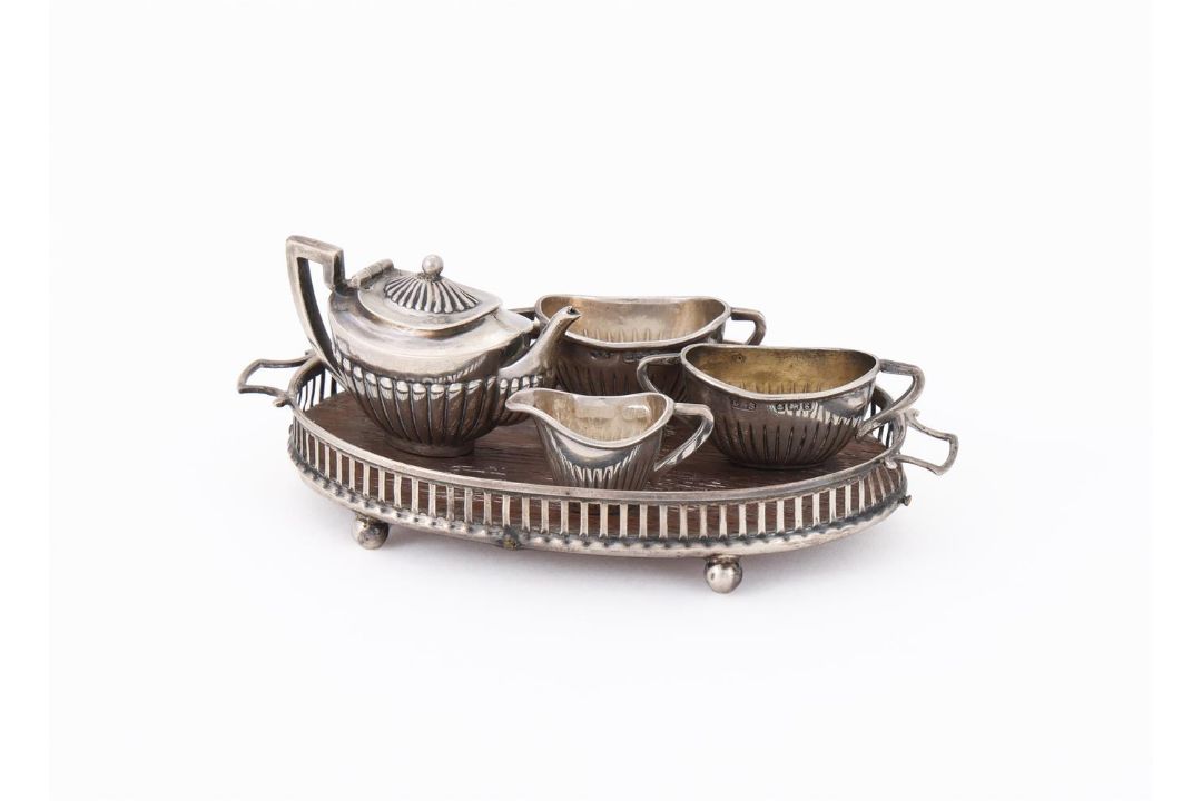 AN EDWARDIAN SILVER MINIATURE FOUR PIECE TEA SET AND TRAY - Image 1 of 3
