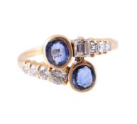 A SAPPHIRE AND DIAMOND CROSSOVER RING