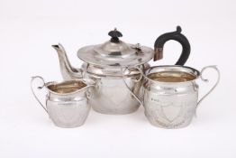 AN EDWARDIAN MATCHED SILVER OVAL THREE PIECE TEA SET