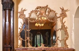 A GILTWOOD WALL MIRROR IN GEORGE III STYLE