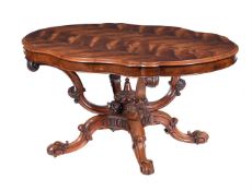 A VICTORIAN CARVED AND FIGURED WALNUT CENTRE TABLE