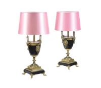 A PAIR OF BLACK SLATE AND GILT METAL MOUNTED TABLE LAMPS