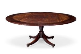 A MAHOGANY CONCENTRIC EXTENDING DINING TABLE IN THE MANNER OF JUPE