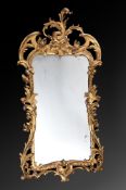 A CARVED GILTWOOD WALL MIRROR, IN IRISH GEORGE II STYLE