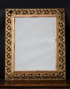 A CARVED GILTWOOD WALL MIRROR