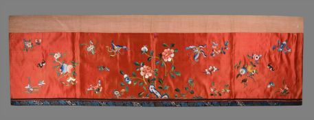 A Chinese red silk door pelmet