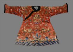A Chinese silk embroidered Child's red dragon celebration robe