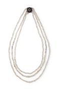 A THREE-ROW NATURAL AND CULTURED PEARL NECKLACE