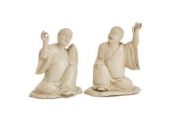 ‡ A PAIR OF STAFFORDSHIRE WHITE SALT-GLAZED STONEWARE FIGURES OF LOHANS, CIRCA 1750