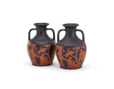 ‡ A PAIR OF WEDGWOOD BLACK BASALT AND IRON-RED ENCAUSTIC DECORATED COPIES OF THE PORTLAND OR BARBERI