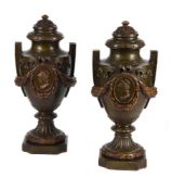 A PAIR OF PATINATED PLASTER MODELS OF URNS