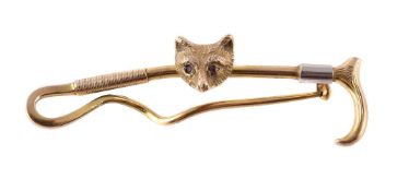 A 9 CARAT GOLD FOX MASK AND CROP STOCK PIN
