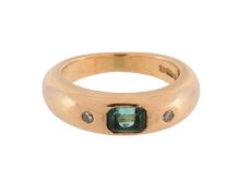 AN EMERALD AND DIAMOND THREE STONE BAND RING, LONDON 1990