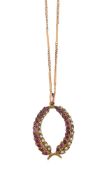 AN EARLY 20TH CENTURY RUBY AND SEED PEARL WREATH PENDANT