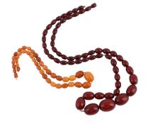 AN AMBER BEAD NECKLACE AND A CHERRY COLOURED RESIN BEAD NECKLACE