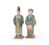 A PAIR OF CHINESE POTTERY AMBER AND GREEN GLAZED TILE-MAKER'S FIGURES, MING DYNASTY