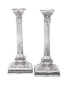 A PAIR OF VICTORIAN SILVER CORINTHIAN CANDLESTICKS