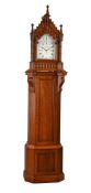 A VICTORIAN GOTHIC REVIVAL CARVED OAK QUARTER-CHIMING BRACKET CLOCK ON PEDESTAL
