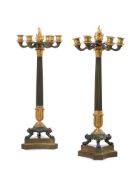 A PAIR OF FRENCH EMPIRE PATINATED AND GILT BRONZE CANDELABRA, AFTER THE ANTIQUE