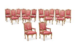 A SET OF FOURTEEN REGENCE STYLE CARVED GILTWOOD AND UPHOLSTERED CHAIRS, POSSIBLY FRENCH