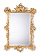 A FRENCH GILT COMPOSITION MIRRORIN LOUIS XV STYLE