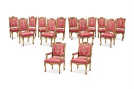 A SET OF FOURTEEN REGENCE STYLE CARVED GILTWOOD AND UPHOLSTERED CHAIRS, POSSIBLY FRENCH
