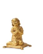 A GILT BRONZE FIGURE OF A CHILD KNEELING AND PRAYING