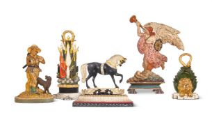 A GROUP OF FIVE PAINTED CAST IRON DOOR STOPS OR PORTERS