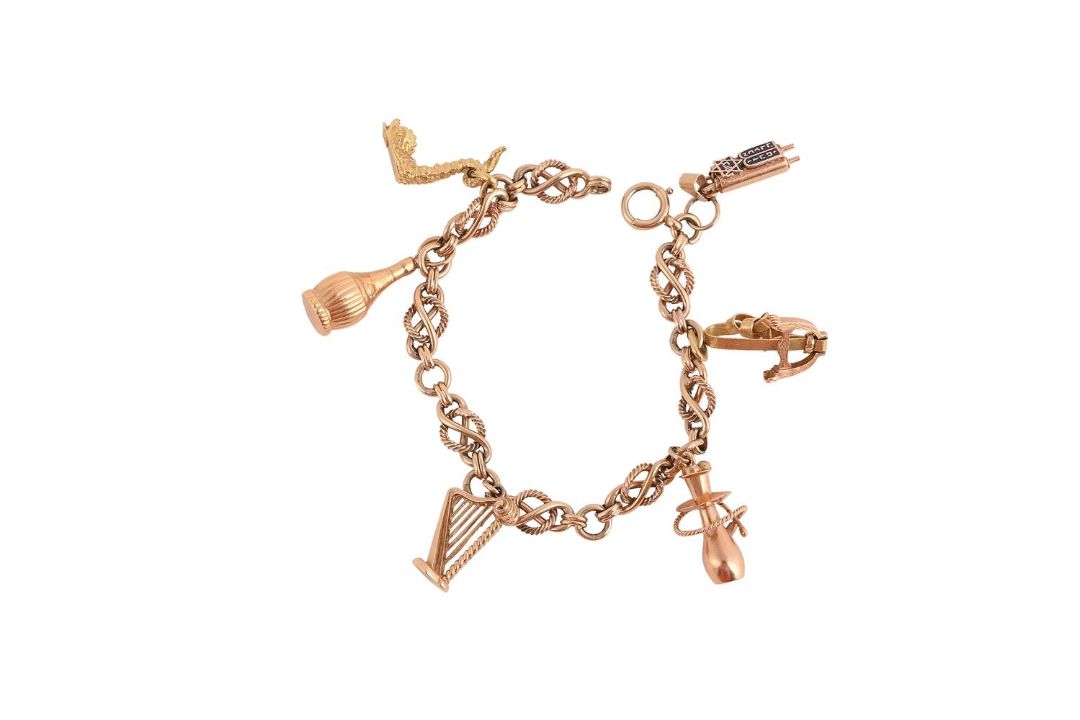A 9CT GOLD CHARM BRACELET