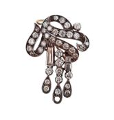 A SCROLLING DIAMOND SET BROOCH