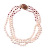 A THREE STRAND CULTURED PEARL AND RUBY NECKLACE