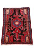 A SMALL RED SHIRAZ GROUND RUG
