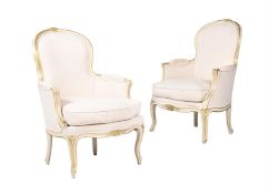 TWO SIMILAR LOUIS XVI CREAM PAINTED AND PARCEL GILT BEECH BERGÈRES, CIRCA 1780