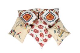 A GROUP OF FIVE CUSHIONS, COVERED IN SUZANI TYPE FABRIC