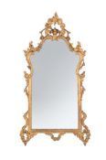 A CARVED GILTWOOD BAROQUE MIRROR, IN LOUIS XV STYLE, 19TH CENTURY