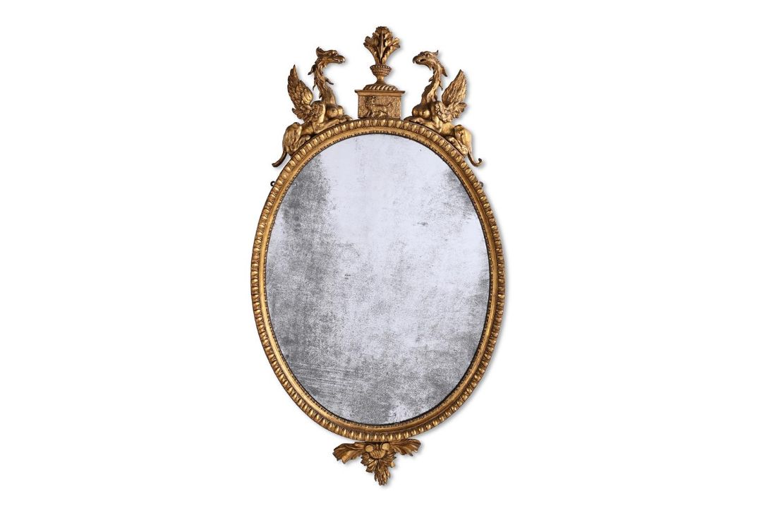 A LARGE GEORGE III CARVED GILTWOOD OVAL MIRROR, AFTER DESIGNS BY ROBERT ADAM, CIRCA 1780 - Image 1 of 2