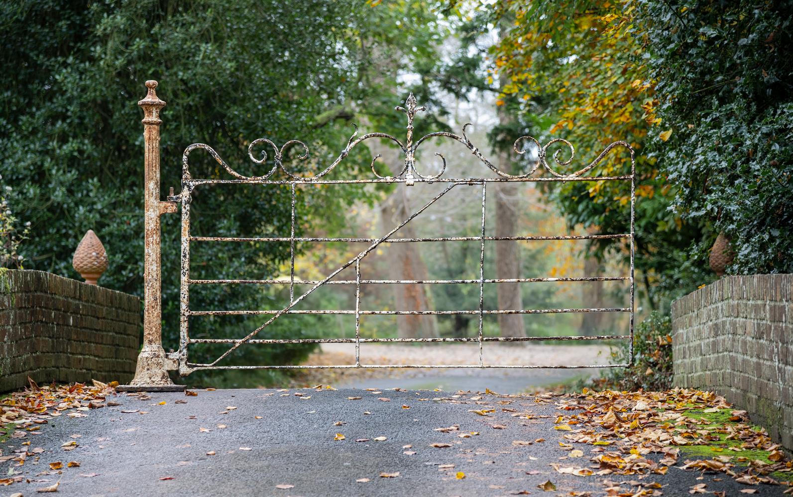 A VICTORIAN WROUGHT IRON AND WHITE PAINTED GATE AND POST, MID 19TH CENTURY