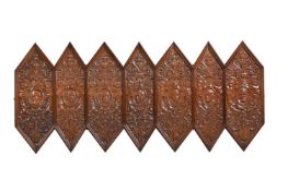 A WALNUT FRAMED CARVED WOOD WALL PANEL, LAST QUARTER 19TH CENTURY