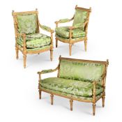 A CARVED GILTWOOD SALON SUITE COMPRISING A SETTEE AND A PAIR OF FAUTEUILS A LA REINE, 19TH CENTURY