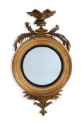 A LARGE REGENCY CARVED GILTWOOD CONVEX MIRROR, CIRCA 1820