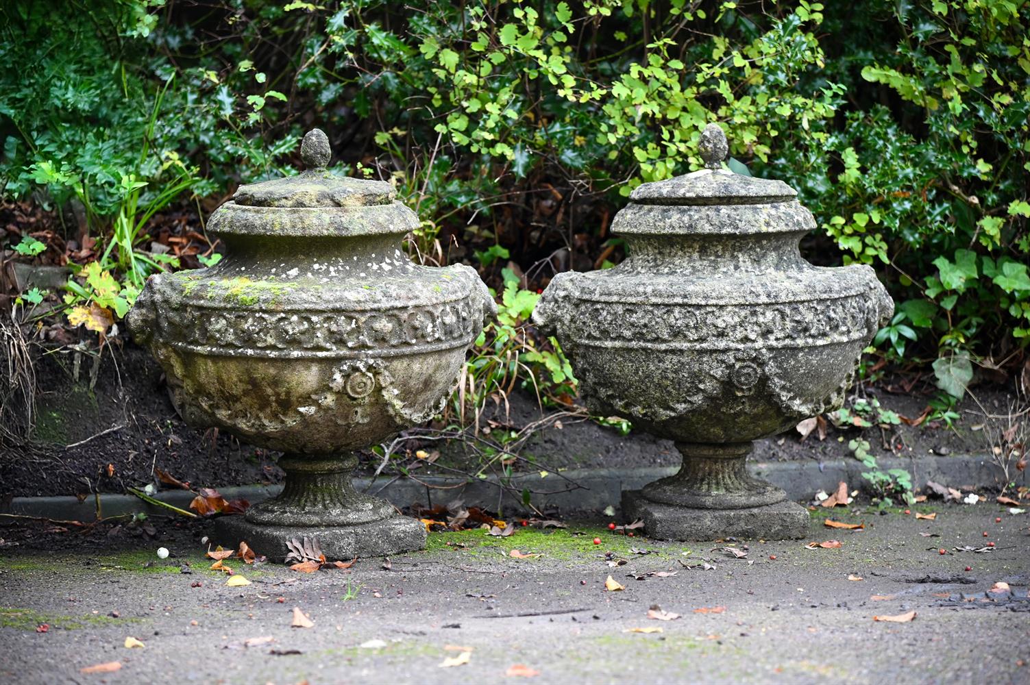 A PAIR OF NEOCLASSICAL COMPOSITION URNS AND LIDS, 19TH CENTURY