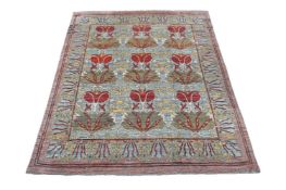 AN USHAK CARPET, AFTER DESIGNS BY C. F. A. VOYSEY, approximately 442 x 354cm